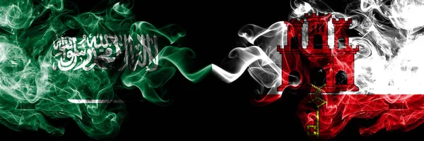 Saudi Arabia Kingdom vs Gibraltar smoky mystic flags placed side by side. Thick colored silky smoke flags of Arabic, Arabian and Gibraltar — Stock Photo, Image