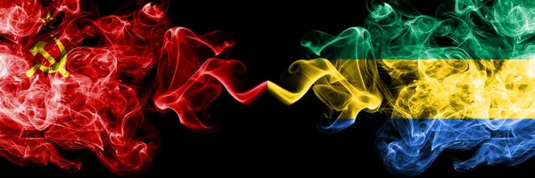 Communist vs Gabon, Gabonese abstract smoky mystic flags placed side by side. Thick colored silky smoke flags of Communism and Gabon, Gabonese — Stock Photo, Image
