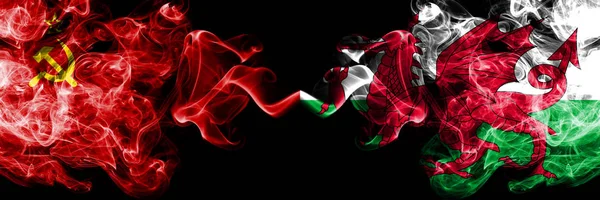 Communist vs Wales, Welsh abstract smoky mystic flags placed side by side. Thick colored silky smoke flags of Communism and Wales, Welsh — Stock Photo, Image