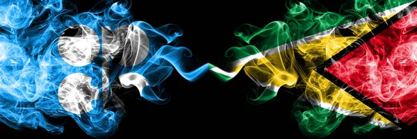 Opec vs Guyana, Guyanese abstracte rokerige mystieke vlaggen naast elkaar geplaatst. Dikke gekleurde zijdeachtige rook vlaggen van Opec en Guyana, Guyana, Guyana — Stockfoto