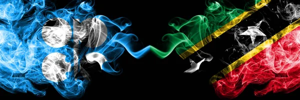 Opec vs Saint Kitts і Nevis abstract smoky mystic прапори розміщені пліч-о-пліч. Товстий колір шовковий дим прапори Опека і Сент-Кіттс і Невіс — стокове фото