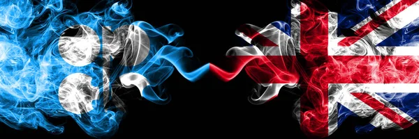 Opec vs Royaume-Uni, British abstract smoky mystic flags placed side by side. Drapeaux de fumée soyeux de couleur épaisse d'Opec et du Royaume-Uni, britannique — Photo