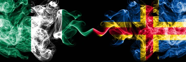 Nigérie vs Aland abstraktní kouřové mystické vlajky umístěny vedle sebe. Silné barevné hedvábné kouřové vlajky Nigérie a Alandu — Stock fotografie