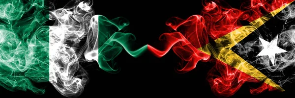 Nigeria vs East Timor abstract smoky mystic flags placed side by side. Thick colored silky smoke flags of Nigerian and East Timor — Stock Photo, Image