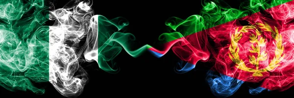 Nigeria vs Eritrea abstract smoky mystic flags placed side by side. Thick colored silky smoke flags of Nigerian and Eritrea — Stock Photo, Image