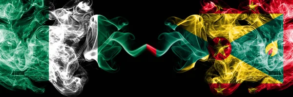 Nigeria vs Grenada abstract smoky mystic flags placed side by side. Thick colored silky smoke flags of Nigerian and Grenada — Stock Photo, Image