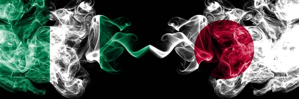 Nigeria vs Japan, Japanese abstract smoky mystic flags placed side by side. Thick colored silky smoke flags of Nigerian and Japan, Japanese — Stock Photo, Image