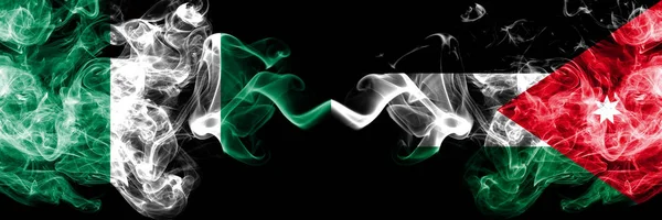 Nigeria vs Jordan, Jordanian abstract smoky mystic flags placed side by side. Thick colored silky smoke flags of Nigerian and Jordan, Jordanian — Stock Photo, Image