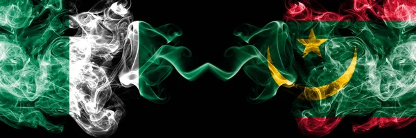 Nigeria vs Mauritania, Mauritanian abstract smoky mystic flags placed side by side. Thick colored silky smoke flags of Nigerian and Mauritania, Mauritanian — Stock Photo, Image
