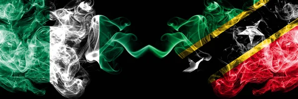 Nigeria vs Saint Kitts and Nevis abstract smoky mystic flags placed side by side. Thick colored silky smoke flags of Nigerian and Saint Kitts and Nevis — Stock Photo, Image