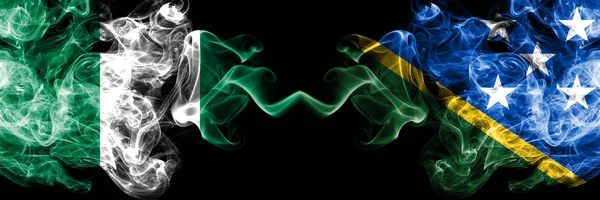 Nigeria vs Solomon Islands abstract smoky mystic flags placed side by side. Thick colored silky smoke flags of Nigerian and Solomon Islands — Stock Photo, Image