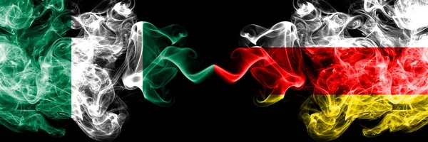 Nigeria vs South Ossetia abstract smoky mystic flags placed side by side. Thick colored silky smoke flags of Nigerian and South Ossetia — Stock Photo, Image