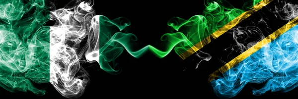 Nigeria vs Tanzania, Tanzanian abstract smoky mystic flags placed side by side. Thick colored silky smoke flags of Nigerian and Tanzania, Tanzanian — Stock Photo, Image