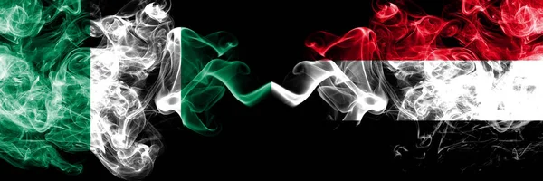 Nigeria vs yemen, jemenitischen abstrakten rauchigen mystischen Flaggen nebeneinander platziert. dicke, seidige Rauchfahnen nigerianischer und jemenitischer Herkunft, Jemen — Stockfoto