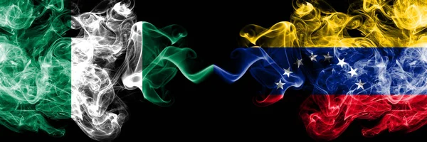 Nigeria vs Venezuela, Venezuelan abstract smoky mystic flags placed side by side. Thick colored silky smoke flags of Nigerian and Venezuela, Venezuelan — Stock Photo, Image