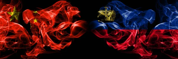 China vs Liechtenstein, Liechtensteins smoke flags placed side by side. Thick colored silky smoke flags of Chinese and Liechtenstein, Liechtensteins — Stock Photo, Image