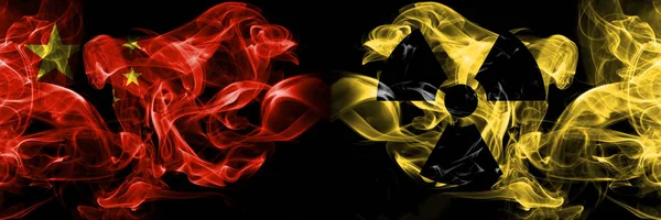 China vs Nuclear, radioactive, radiation, hazard smoke flags placed side by side. Thick colored silky smoke flags of Chinese and Nuclear, radioactive, radiation, hazard — Stock Photo, Image