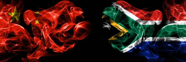 Китай против ЮАР, африканские дымовые флаги, размещенные бок о бок. Толстые цветные шелковистые дымовые флаги Китая и Южной Африки, Африки — стоковое фото