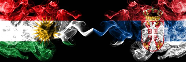 Kurdistan vs Serbia, Serbian smoke flags placed side by side. Th — Stock Photo, Image