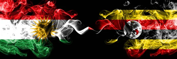 Kurdistan vs Uganda, Ugandan smoke flags placed side by side. Th — Stock Photo, Image