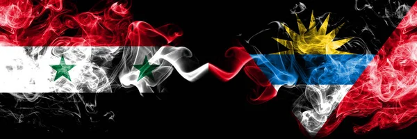 Syria vs Antigua and Barbuda smoke flags placed side by side. Thick colored silky smoke flags of Syrian and Antigua and Barbuda