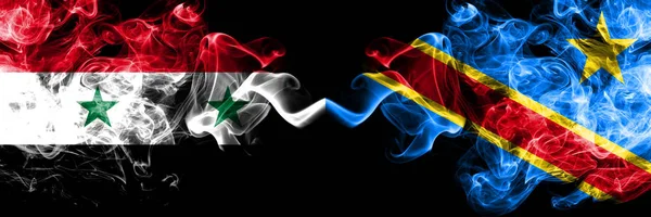 Syrien vs demokratiska republiken Kongo röker flaggor placeras sida vid sida. Tjock färgad silkeslen rök flaggor av syriska och demokratiska republiken Kongo — Stockfoto