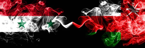 Syria vs Oman, Omani smoke flags placed side by side. Thick colored silky smoke flags of Syrian and Oman, Omani — Stock Photo, Image