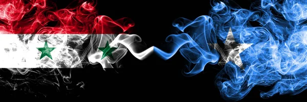 Syria vs Somalia, Somalian smoke flags placed side by side. Thick colored silky smoke flags of Syrian and Somalia, Somalian — Stock Photo, Image