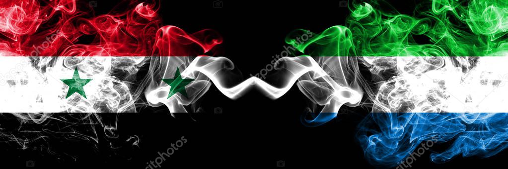 Syria vs Sierra Leone smoke flags placed side by side. Thick colored silky smoke flags of Syrian and Sierra Leone