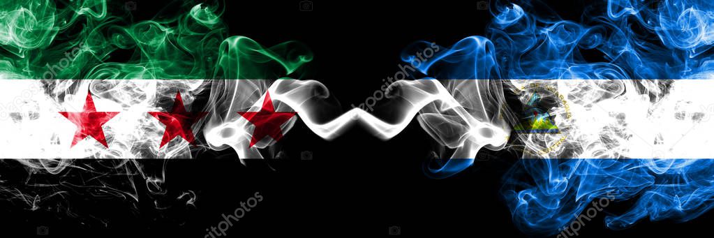 Syrian Arab Republic vs Nicaragua, Nicaraguan smoke flags placed side by side. Thick colored silky smoke flags of Syria opposition and Nicaragua, Nicaraguan