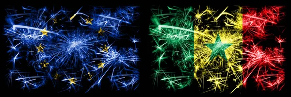 Eu, European Union vs Senegal, Senegalese nieuwjaarsviering sprankelend vuurwerk vlaggen concept achtergrond. Combinatie van twee vlaggen van staten. — Stockfoto