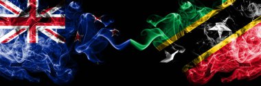 Yeni Zelanda, Saint Kitts ve Nevis 'e karşı yan yana yerleştirilmiş gizemli bayraklar. Kalın renkli ipeksi soyut duman bayrakları