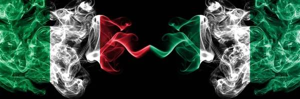 Италия Против Нигерии Нигерийские Дымящиеся Мистические Флаги Размещенные Бок Бок — стоковое фото