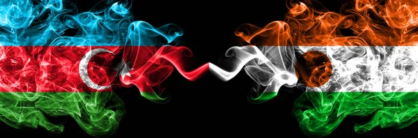 阿塞拜疆 阿塞拜疆对尼日尔 尼日利亚烟熏神秘的旗帜并排放置 浓密的彩色丝状抽象烟旗 — 图库照片