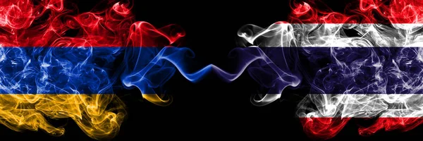 Armenia vs Thailand, Thai smoky mystic flags placed side by side. Thick colored silky abstract smoke flags