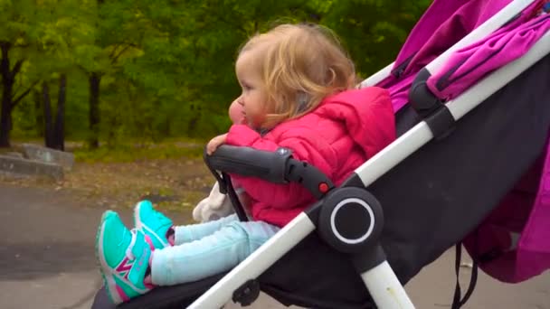 Babymeisje zittend op vervoer — Stockvideo