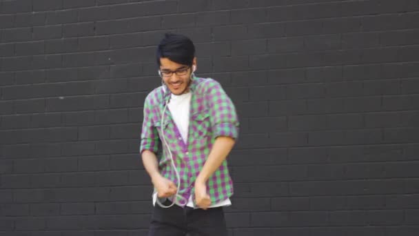 Joven contento en auriculares bailando al aire libre — Vídeos de Stock