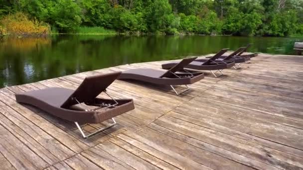 Peu de chaises longues debout sur une jetée en bois 