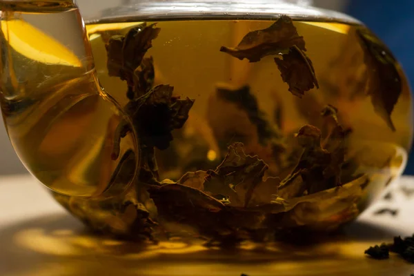 Glass teapot with green chinese tea inside — Stock Photo, Image