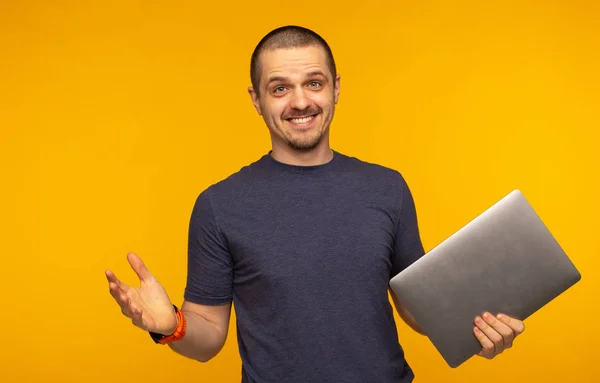 Zaskoczony mężczyzna freelancer lub dewelopera, trzymając laptop i uśmiechając się — Zdjęcie stockowe