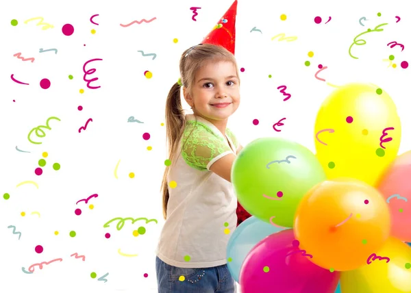 Маленька усміхнена дівчинка святкує день народження з різнокольоровими кульками — стокове фото