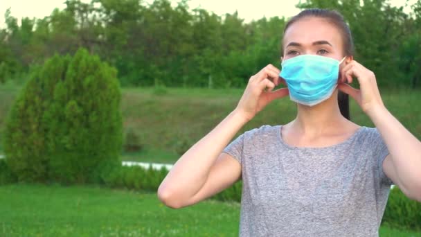 La mujer se quita la máscara médica. Mujer respira profundamente de pie al aire libre . — Vídeo de stock