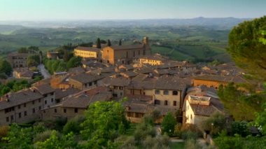 San Gimignano, Toskana, İtalya. San Gimignano görüntüsünü kaydırma Ortaçağ kenti günbatımı ışıklar çatılar. UHD, 4k