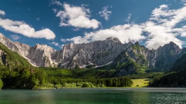 La Italia alpina. Paisaje con lago de montaña, bosque, montañas y nubes. Tiempo transcurrido, 4K. Efecto alejar — Vídeo de stock