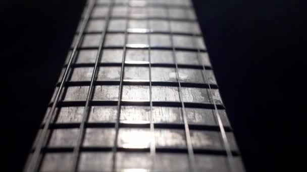 Sliding shot of Electric guitar over black background — Stock Video