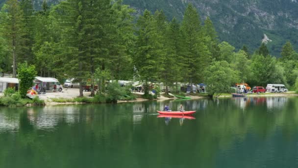 Sjön Bohinj, Slovenien. Bil camping på en sjöstranden i bergen. Bohinj ligger i nationalparken Triglav i Juliska alperna. Panorering skott, 4k — Stockvideo