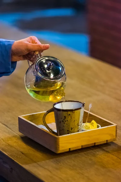 Woman Pouring Tea Teapot Cup Wooden Plate — Stock Photo, Image