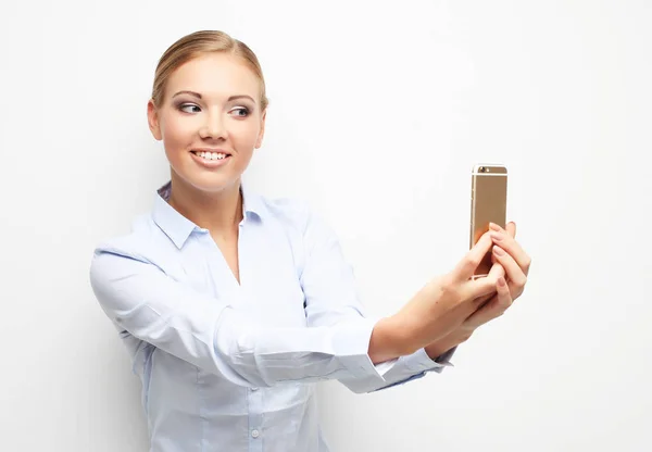 Lifestyle, tehnology and people concept: happy young woman is making selfie photo with smartphone. — Stock Photo, Image