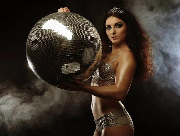 Dancer brunette girl wearing lingerie with disco ball — Stock Photo, Image