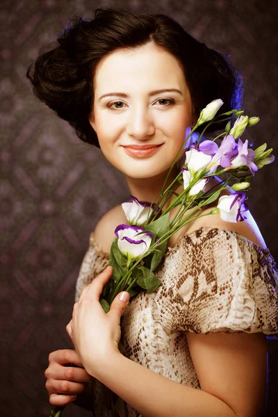 Beautiful brunette woman with lilac flowers — Stock Photo, Image